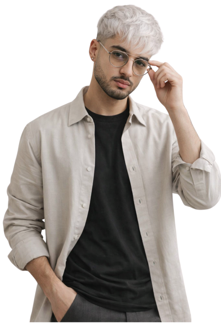 Young man with platinum blond hair wearing glasses and beige overshirt on dark background
